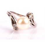Pearl and diamond twist ring, with a 8mm cultured pearl with a round brilliant cut diamond to each
