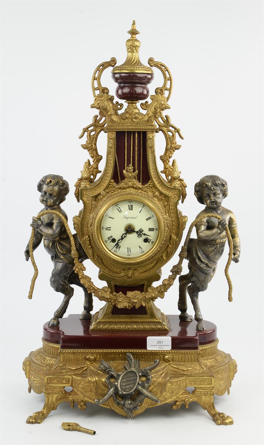 Louis XVI style gilt metal and burgundy porcelain mantel clock, 20th Century, with satyr mounts,