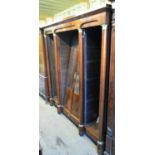 A late 19th century French mahogany cupboard book case, the four sections with central cupboard