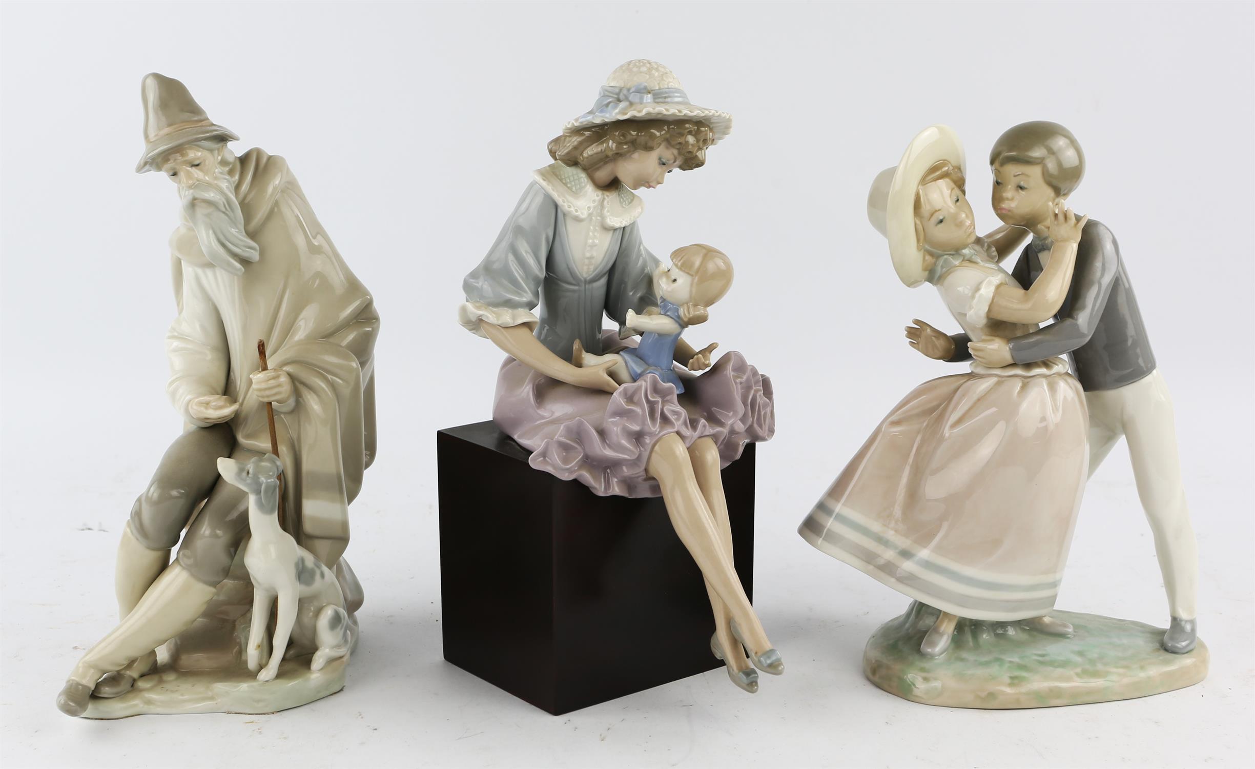 A collection of Lladro porcelain figures including 'Beggar' No 1094, 'Debbie and her Doll' No1379,