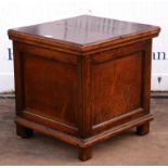 A George III oak box seat commode, of panelled form, the hinged lid revealing a removable seat,