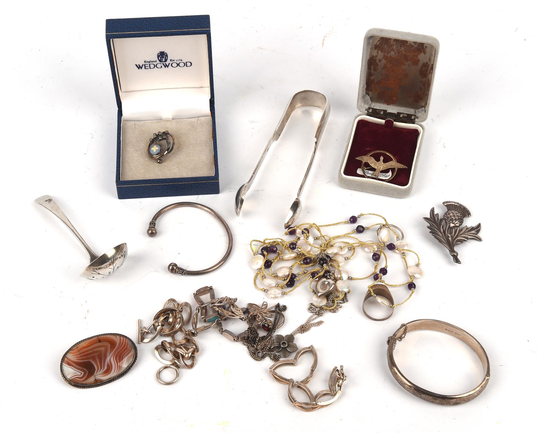 A selection of silver jewellery and items, including a silver spoon, a pair of sugar tongs