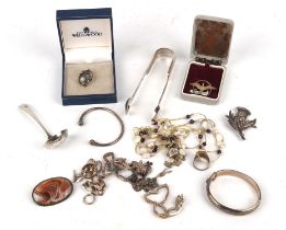 A selection of silver jewellery and items, including a silver spoon, a pair of sugar tongs