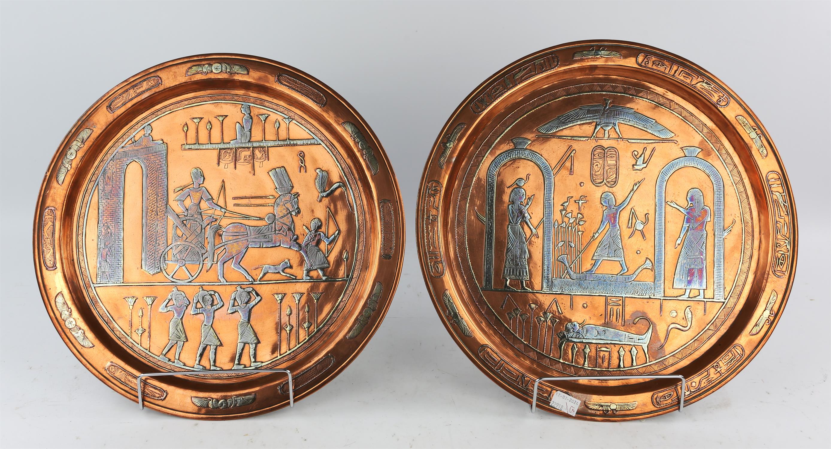 Two Egyptian copper and white metal souvenir plates, depicting scenes of a pharaoh riding a chariot