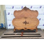 A French Louis XV style walnut double bed, each end quarter veneered with leaf scroll details,
