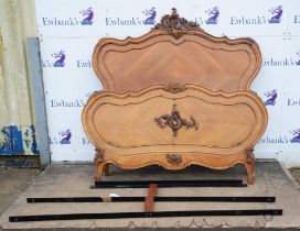 A French Louis XV style walnut double bed, each end quarter veneered with leaf scroll details,