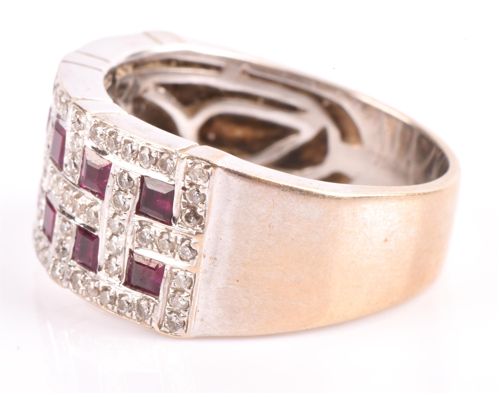 A ruby and diamond band ring, set with twelve square cut rubies, each surrounded by round brilliant - Image 3 of 4