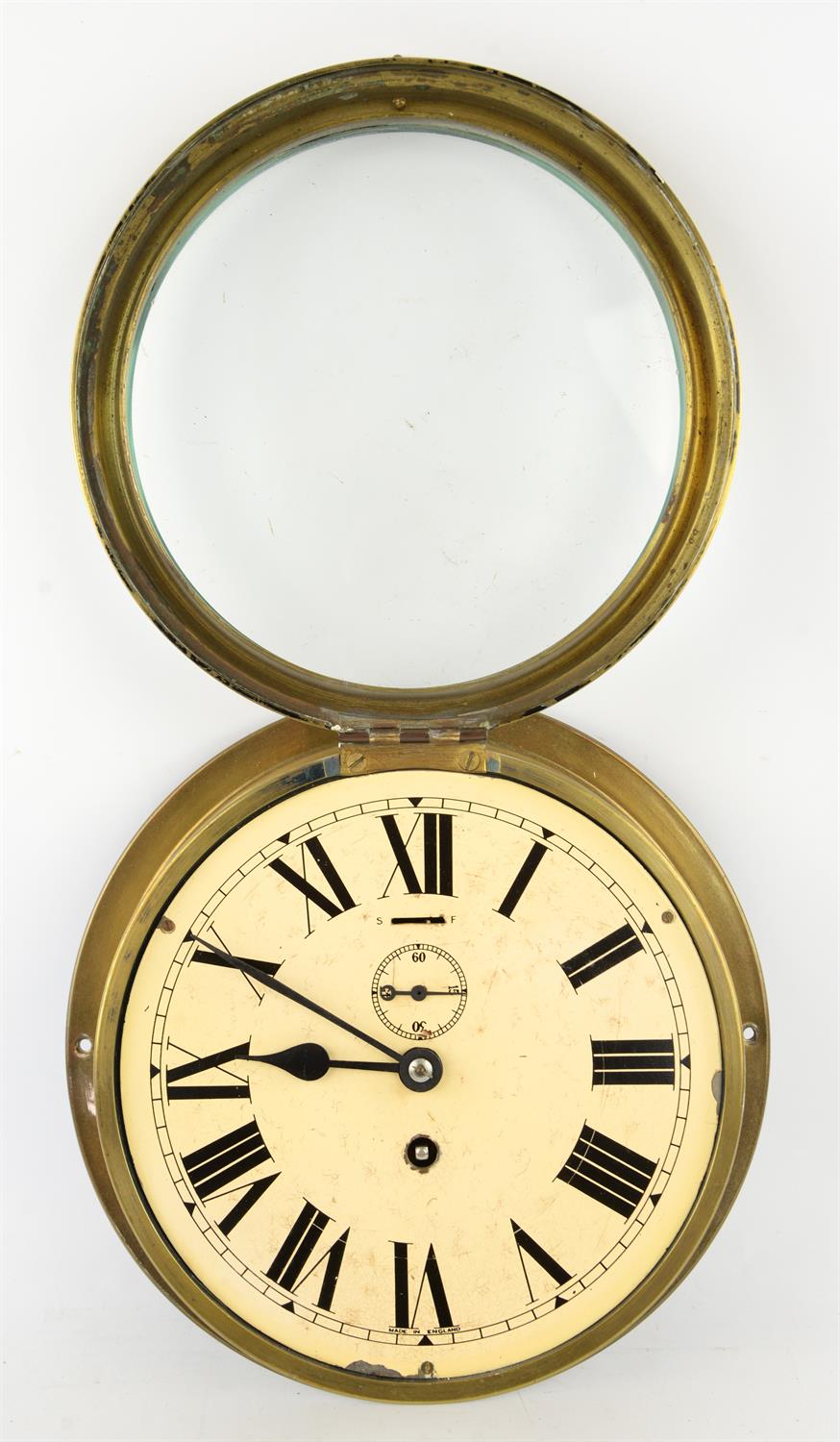 An Edwardian brass wall mounted clock, the 19cm white enamel dial with a winding aperture and - Image 2 of 2