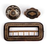 Tortoiseshell pique brooches and a buckle, two brooches, one round and one oval, with base metal