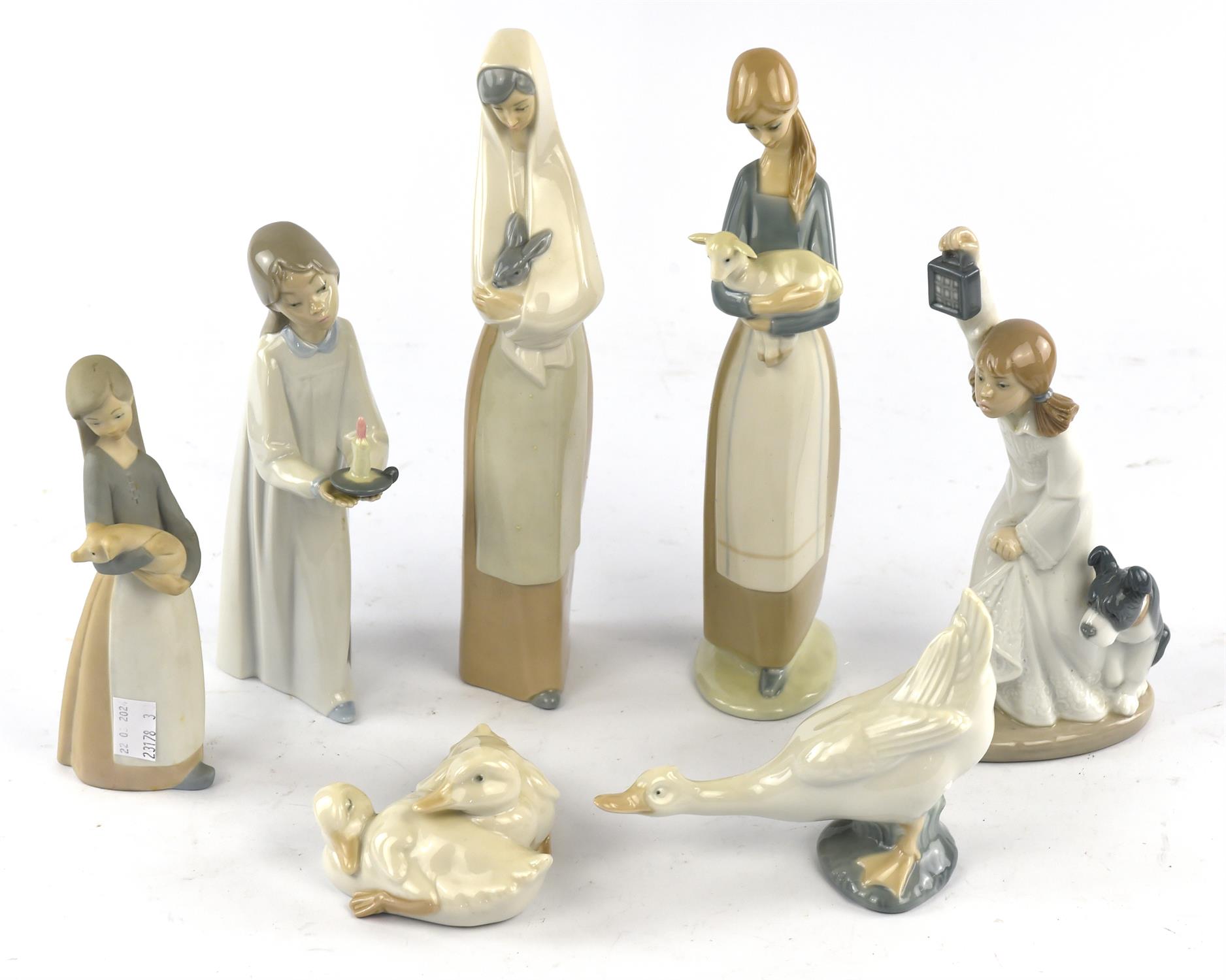 A group of 7 Lladro and Nao figures, 5 boxed.