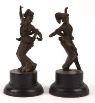 A pair of Balinese [or other South East Asian] bronze dancers; each one on a circular base; overall