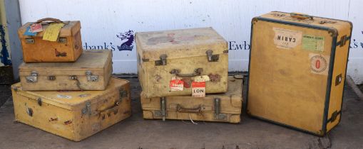 A mid 20th century canvas bound travel case with fitted shoe storage interior and brass hardware,