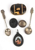A small jewellery box containing a tortoise shell purse, a round pique brooch, a jet teardrop