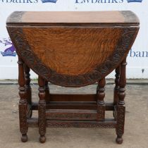 A Charles II style small oak gateleg table, with a carved oval top, 1900s, H 69cm, W 66cm,