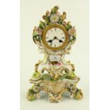 French porcelain clock with floral decoration on stand with pendulum and key, H34cm