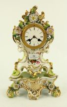 French porcelain clock with floral decoration on stand with pendulum and key, H34cm