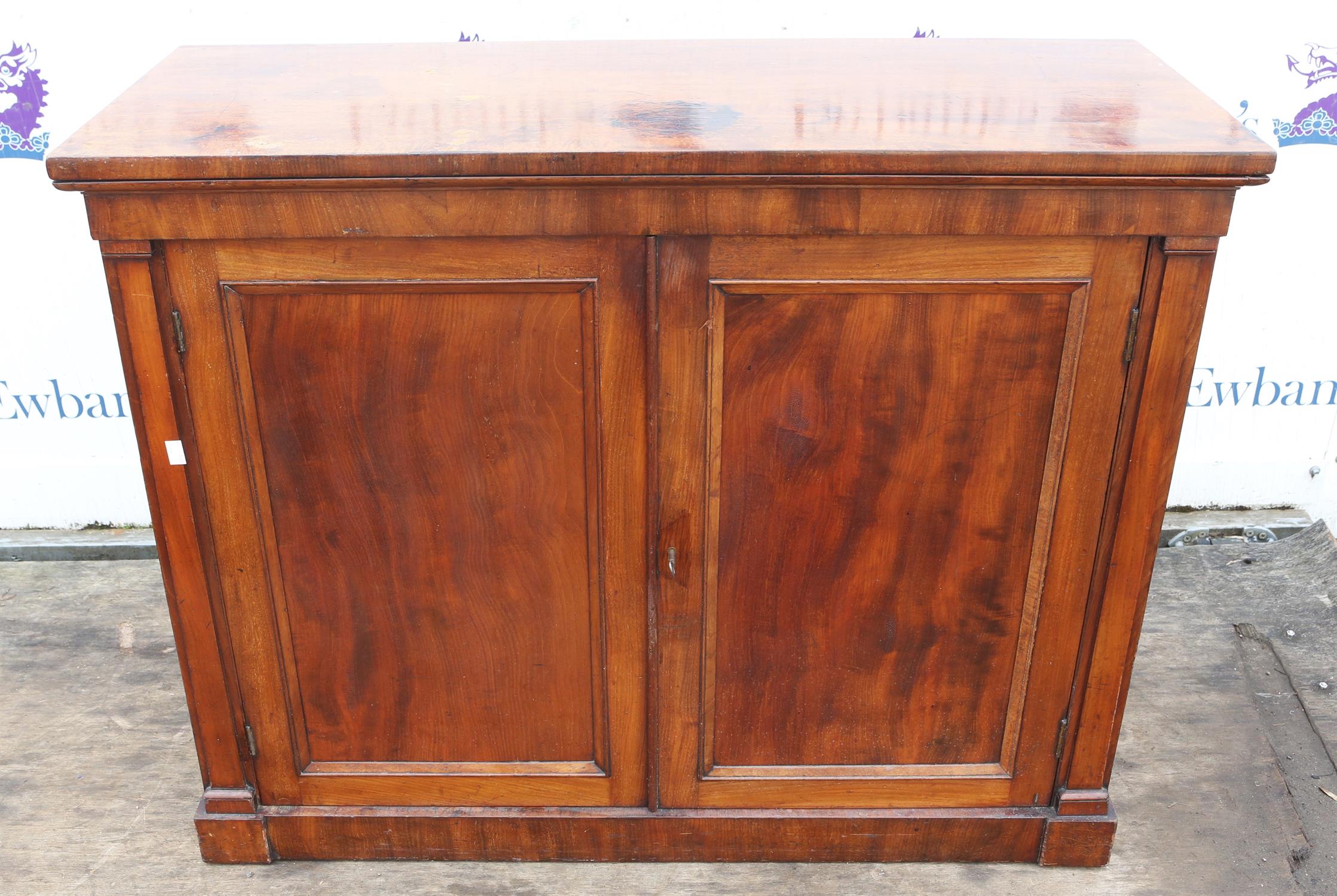 Mahogany cupboard, 19th Century, with two panelled doors enclosing a shelf, on plinth bae,