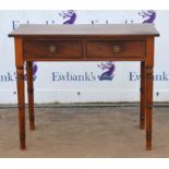 A George IV mahogany side table, the solid top above two drawers, on simulated bamboo turned legs,