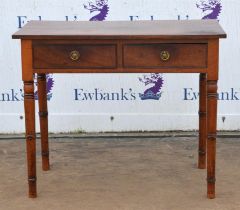 A George IV mahogany side table, the solid top above two drawers, on simulated bamboo turned legs,