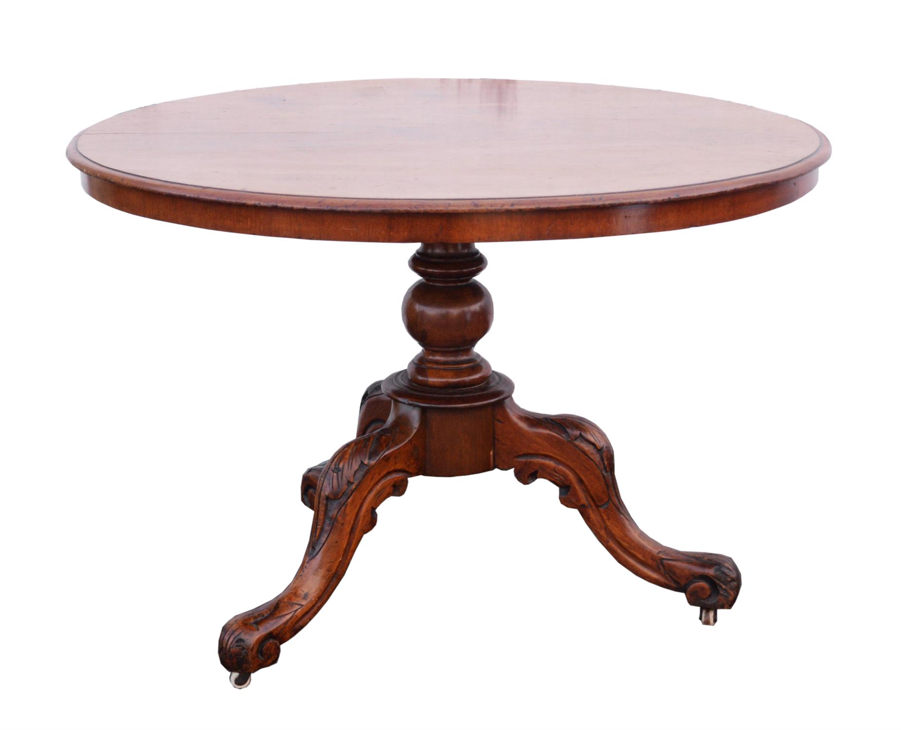 Victorian walnut breakfast table, circular top on a baluster stem with leaf carved cabriole legs,