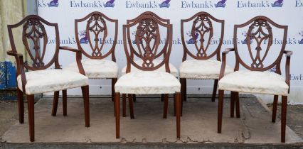 A set of six George III style mahogany dining chairs, of shield back Hepplewhite form,