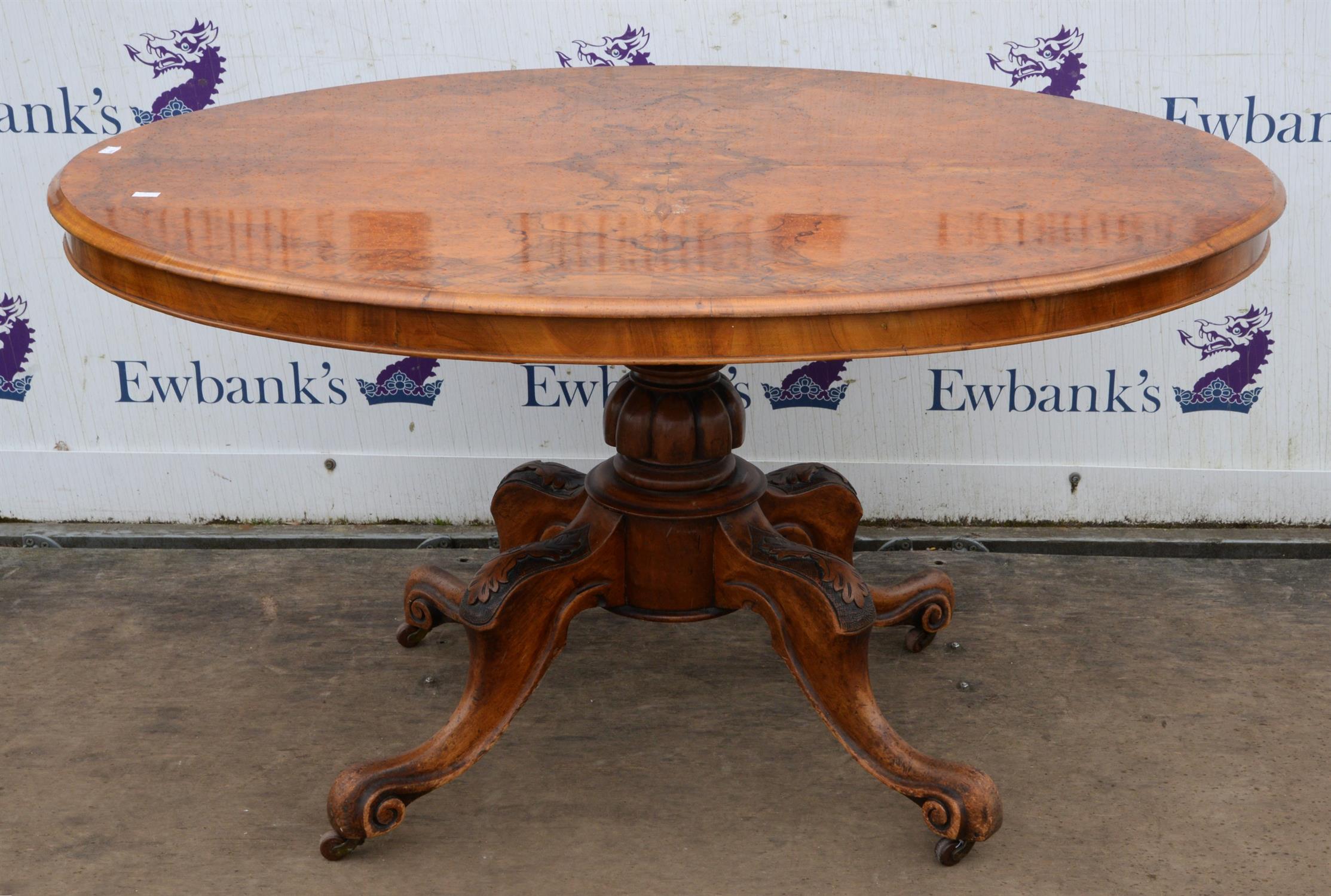 A Victorian walnut oval centre table, the burr walnut quarter veneered top on quadruple cabriole