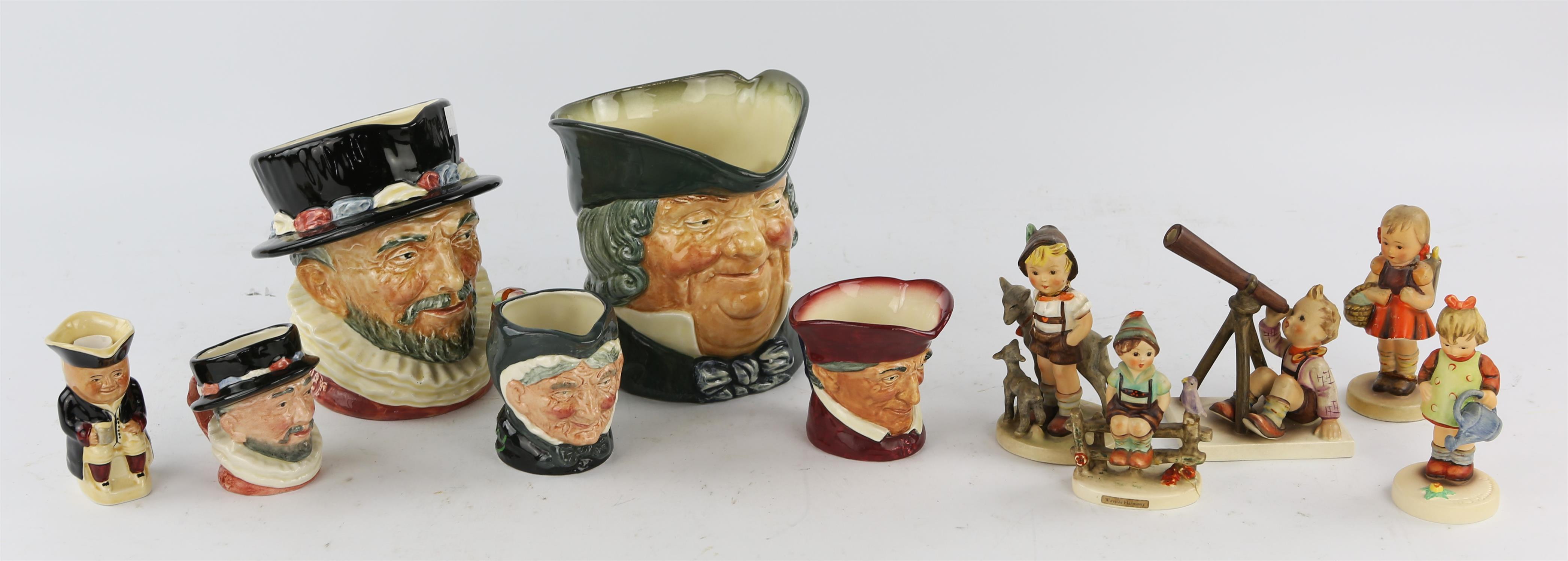 A small collection of Royal Doulton Toby character jugs, Hummel figures and scale model toy cars.