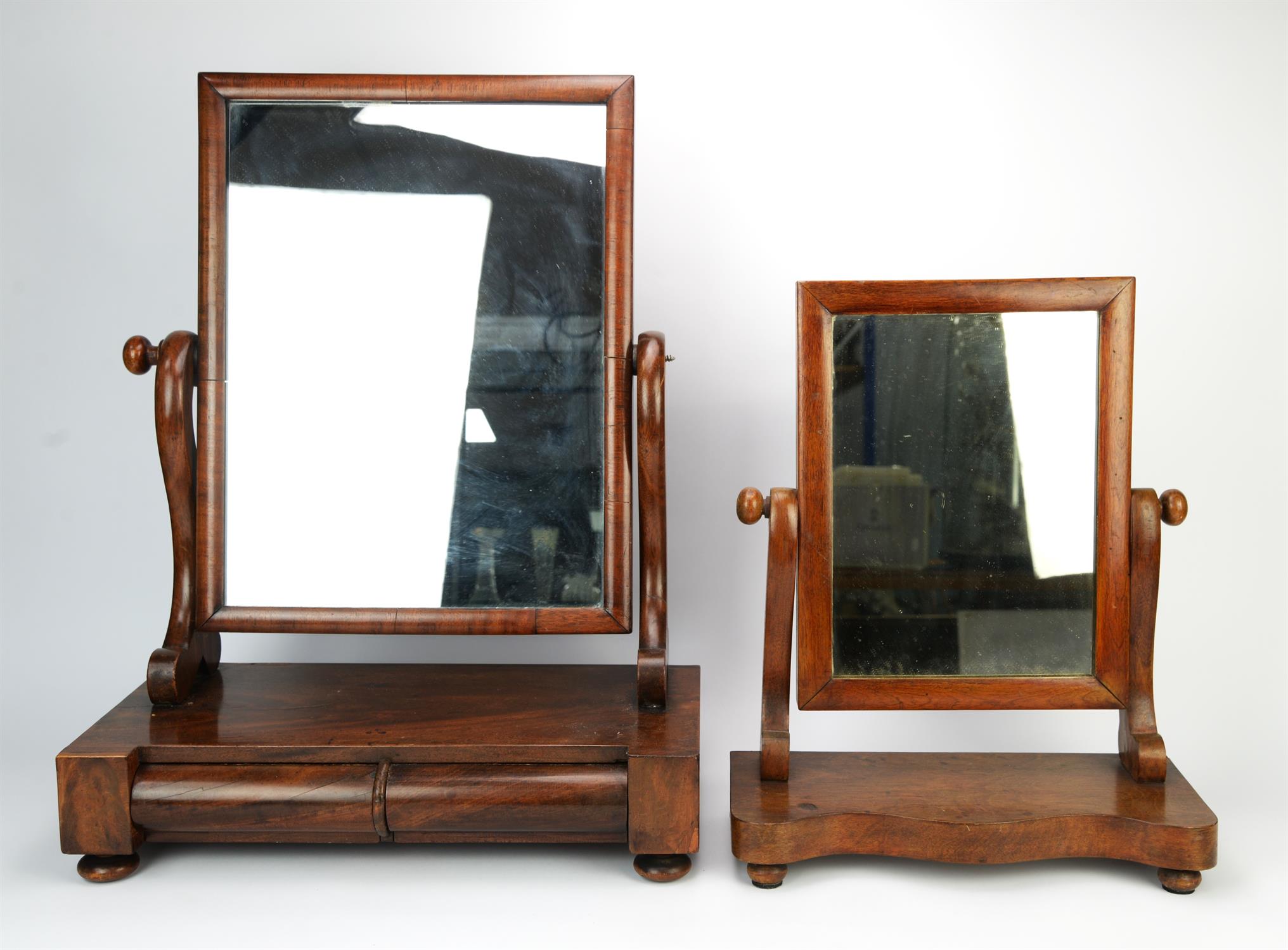 A William IV mahogany dressing table mirror, adjustable and on S-scroll supports,