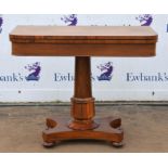 A William IV rosewood card table, the foldover top and lotus leaf carved column on bun feet with