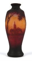 Daum, a glass vase, decorated with a continuous landscape of a river and trees, in a sunset,