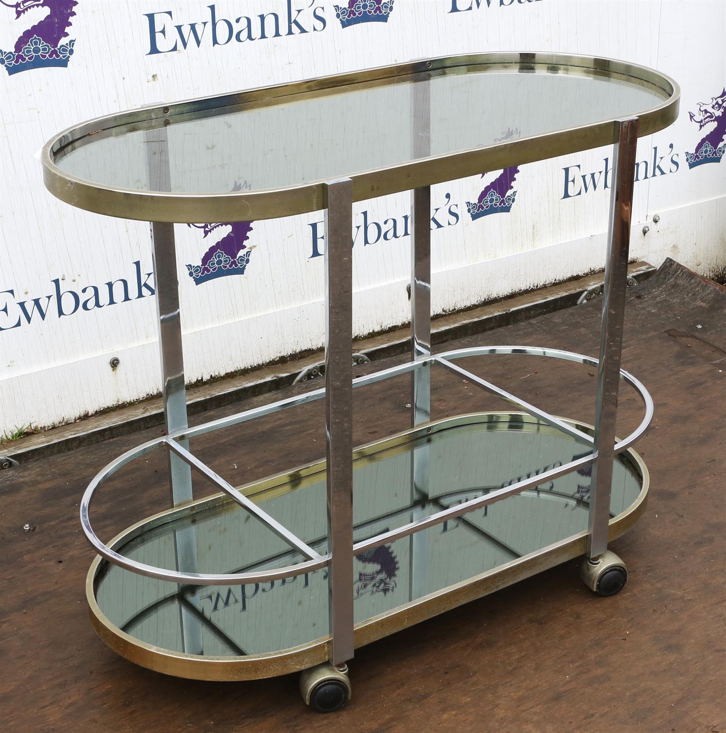 Unknown Designer, a chromed metal bar trolley, with glass top, above mirrored base, on casters, - Image 4 of 5