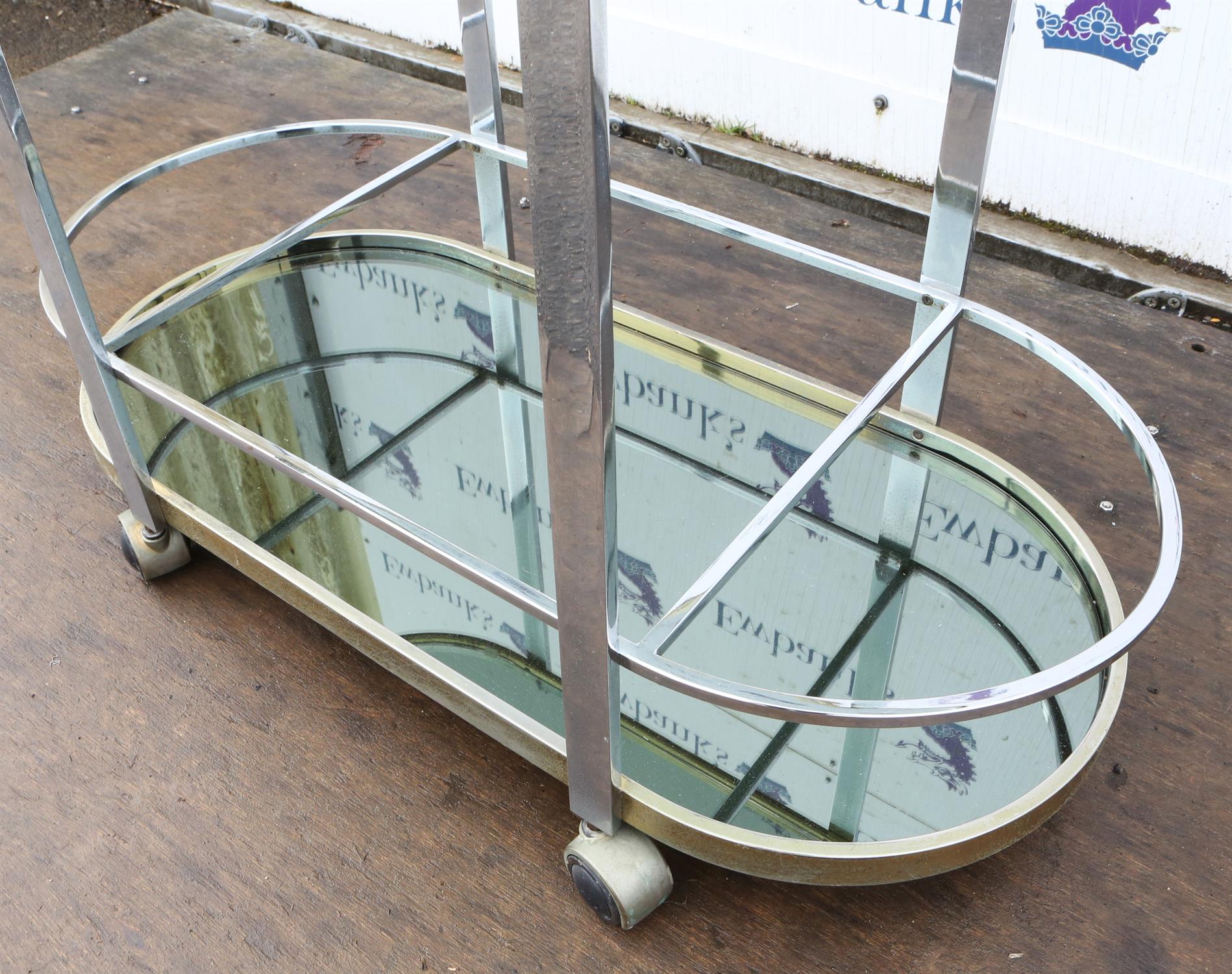 Unknown Designer, a chromed metal bar trolley, with glass top, above mirrored base, on casters, - Image 2 of 5