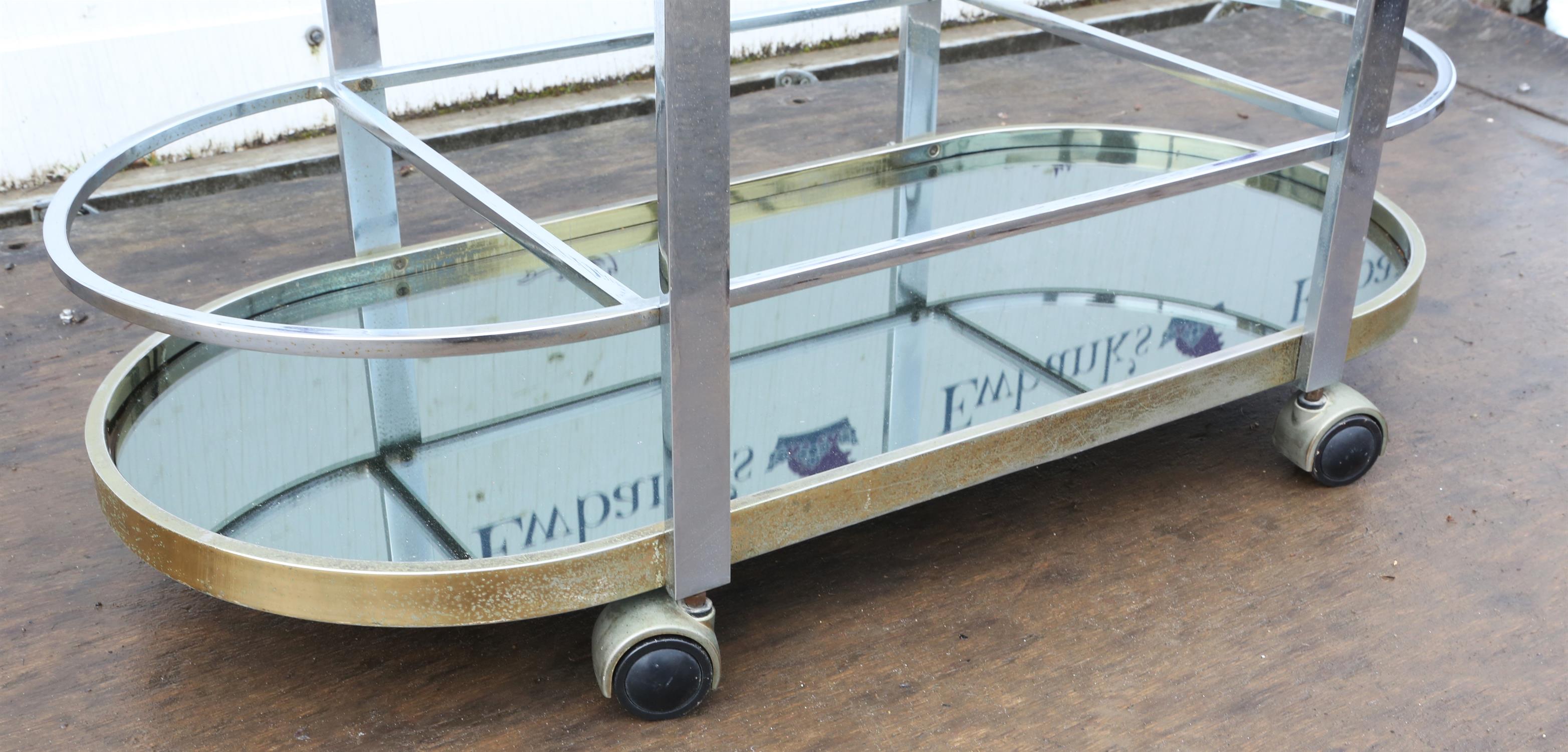 Unknown Designer, a chromed metal bar trolley, with glass top, above mirrored base, on casters, - Image 5 of 5