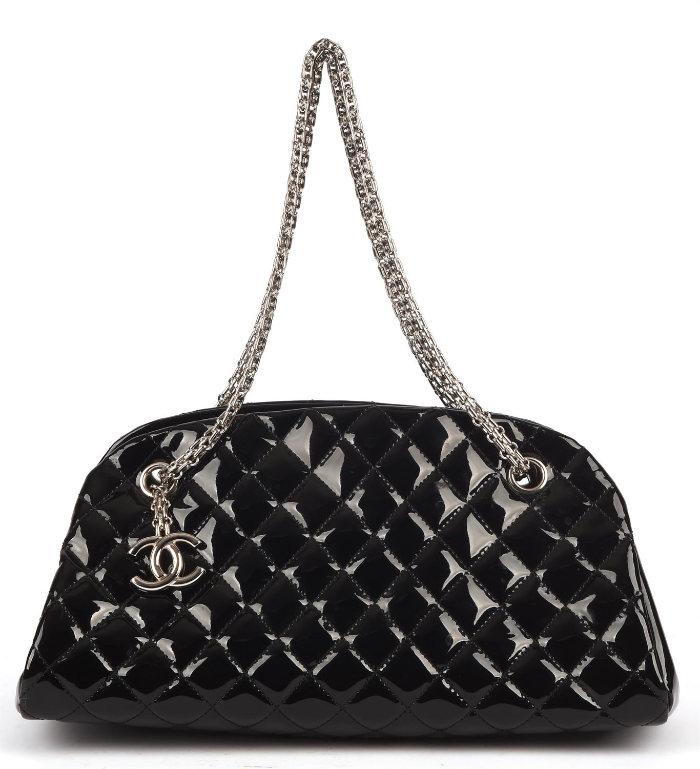 CHANEL quilted black patent Mademoiselle handbag with silver hardware and burgundy canvas interior.