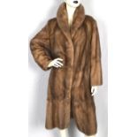 A sot grey/beige mink fur coat with coffee satin lining two hip pockets and fastens with fur hooks.