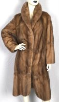 A sot grey/beige mink fur coat with coffee satin lining two hip pockets and fastens with fur hooks.
