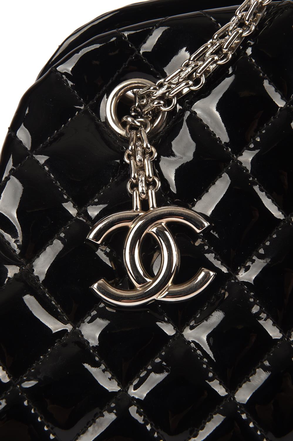 CHANEL quilted black patent Mademoiselle handbag with silver hardware and burgundy canvas interior. - Image 3 of 8