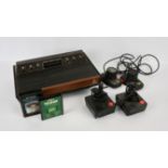 Atari 2600 console with 2 paddles, 2 classic joysticks and 2 loose games Games include: Space