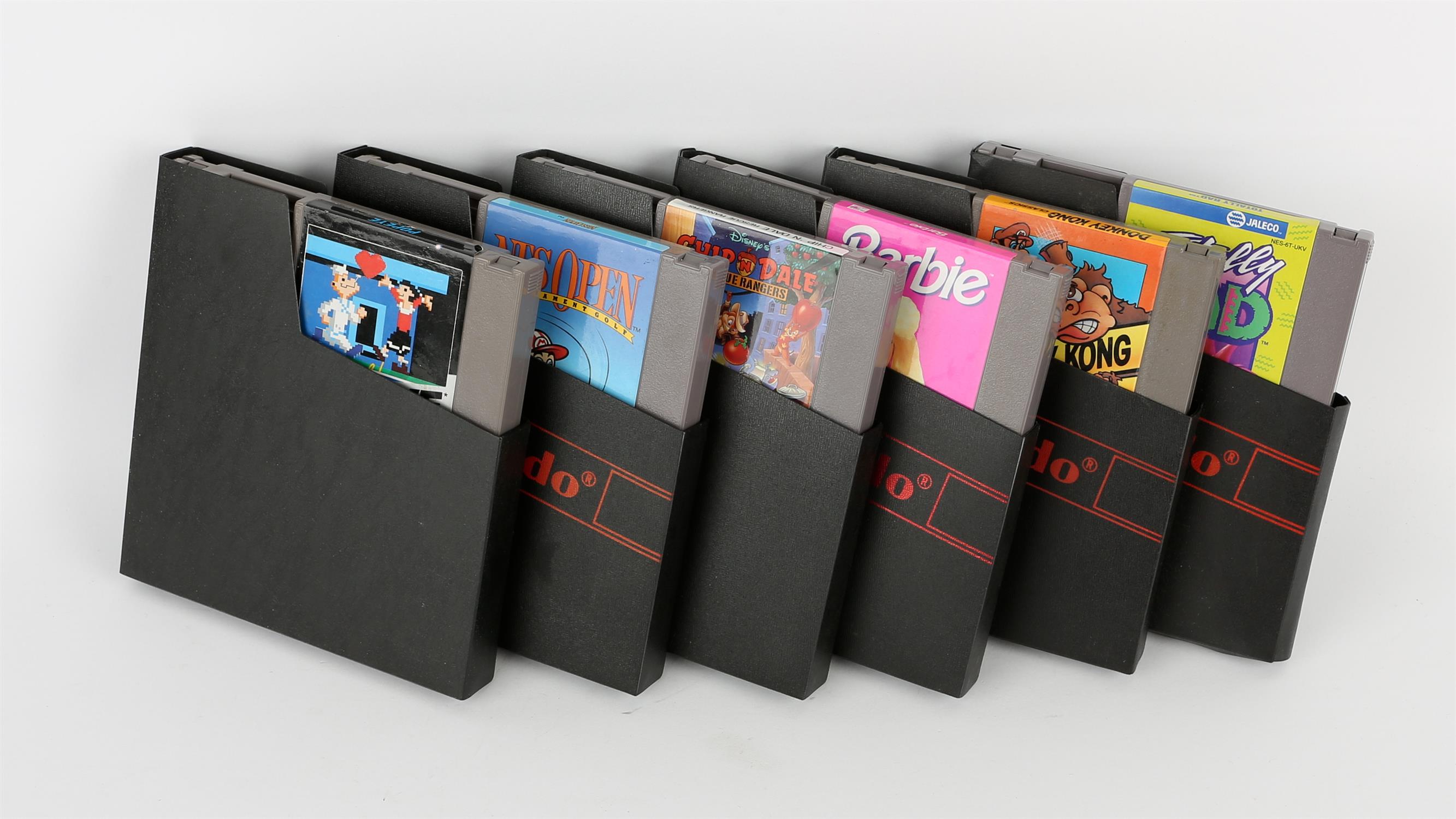 An assortment of 6 loose Nintendo Entertainment System (NES) cartridges Games include: Barbie,