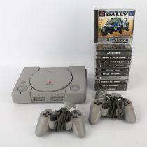 PlayStation 1 (PS1) console unboxed with 2 controllers, 11 games and power cables Games include: