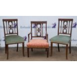 A pair of Edwardian mahogany and crossbanded salon chairs, together with an en suite armchair,