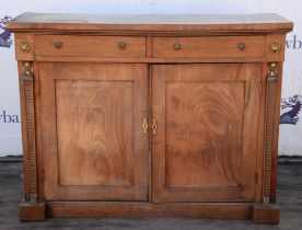 A George IV mahogany side cabinet, the doors in flame mahogany flanked by tapered pilasters with