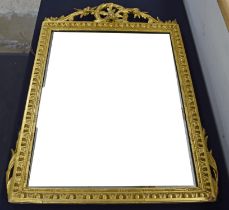 A 19th century giltwood rectangular wall mirror with foliate carved crest. (later glass plate),