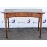 An Edwardian mahogany dressing table, in the George III style, of concave outline,