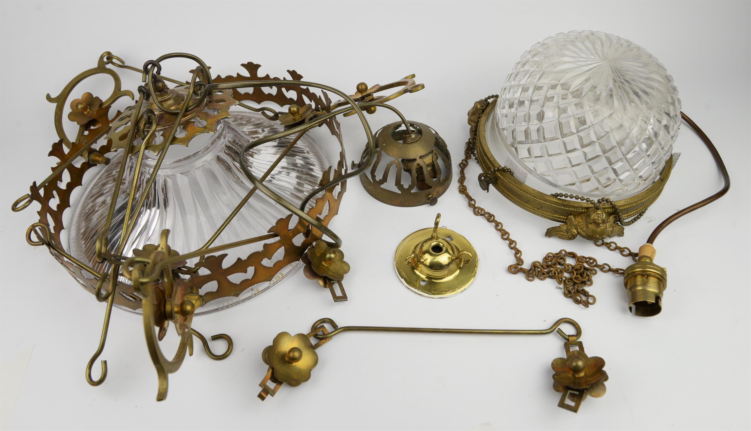 A late 19th century ceiling light of domed cut glass form enclosed by a brass circlet moulded with