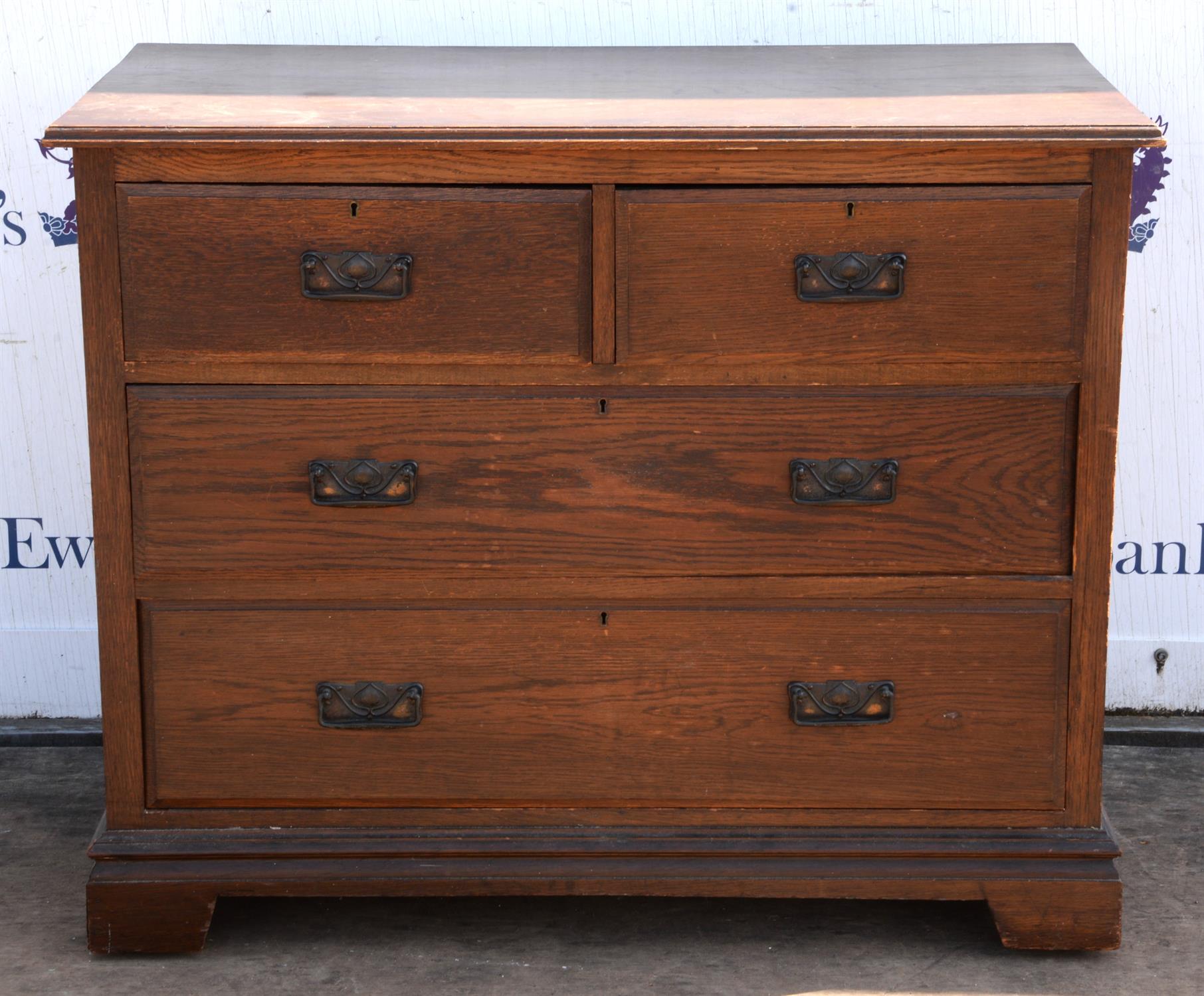 An Edwardian oak dressing chest of drawers, formerly with mirror surmount, the bracket feet with