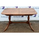 A Regency style mahogany extending dining table, crossbanded and quarter veneered with one leaf