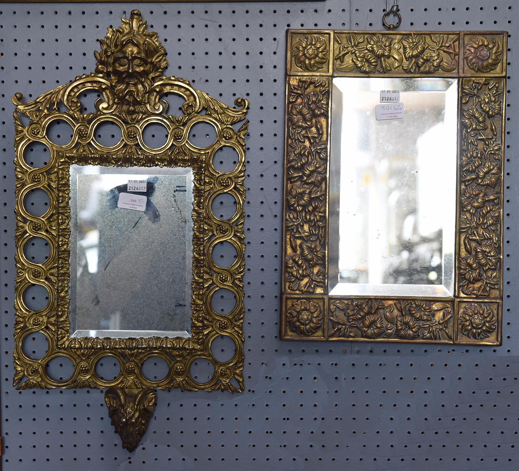 An Arts & Crafts style rectangular wall mirror with brass foliate embossed wide border, height 43cm,