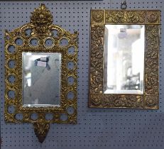 An Arts & Crafts style rectangular wall mirror with brass foliate embossed wide border, height 43cm,