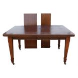 An Edwardian mahogany extending dining table, legs satinwood banded and with ceramic castors,